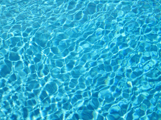 Obraz na płótnie Canvas close up shot of blue textured water background