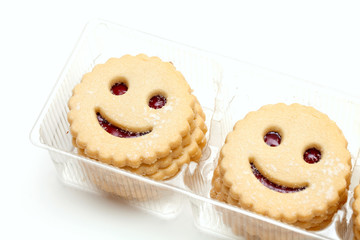 smiling cookies in plastic box isolated on white