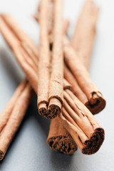 Heap of cinnamon sticks, focus on foreground