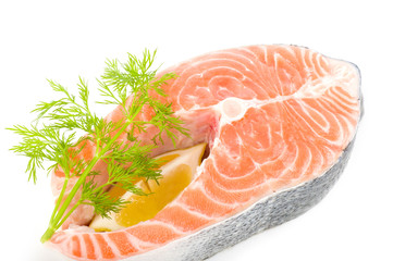 Piece of a salmon with lemon and dill on a white background