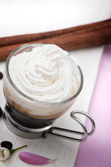 Coffee with cream on white towel and pink background