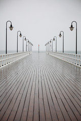 old pier in rain on Baltic sea Orlowo Gdynia Poland