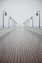 Rolgordijnen old pier in rain on Baltic sea Orlowo Gdynia Poland © anetlanda