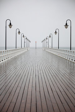 Fototapeta old pier in rain on Baltic sea Orlowo Gdynia Poland
