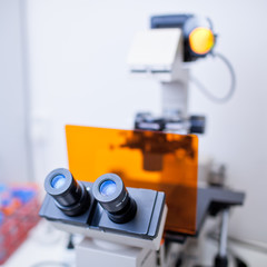 modern microscope in a lab  (color toned image; shallow DOF)