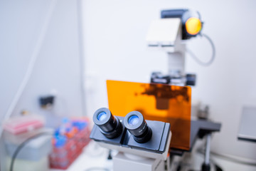 modern microscope in a lab  (color toned image; shallow DOF)