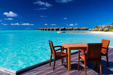 Table and chairs at beach restaurant