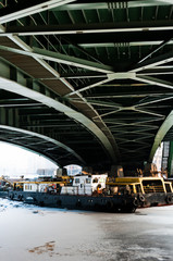 Tugs under the green bridge