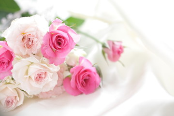 pink roses bouquet on white silk