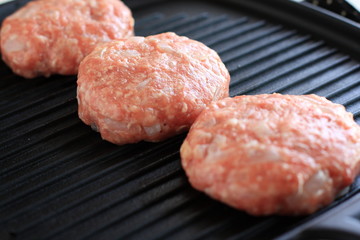 Hamburger on grill pan for cooking image