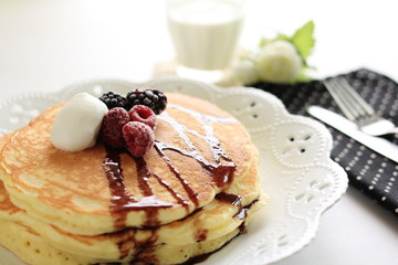 Western breakfast, pan cake with berries and fresh cream
