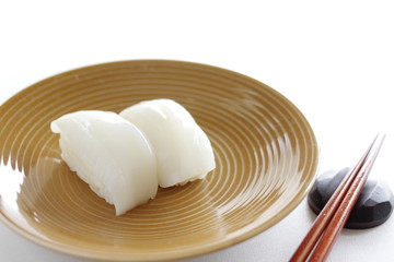 Japanese cuisine, squid sushi with chopsticks