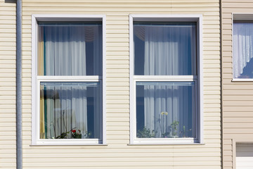 Fototapeta na wymiar Standard windows in mass plastic house