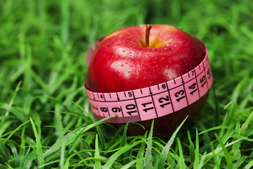 fresh apple with measuring tape