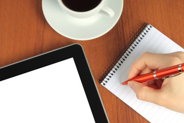 Touch screen device, notepad, writing hand and cup of coffee