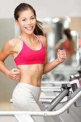 Woman running on treadmill gym