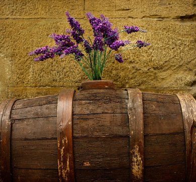 Purple flowers on old barrel.