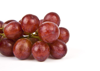Red grapes on white background.