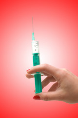 Hand holding syringe isolated on the white