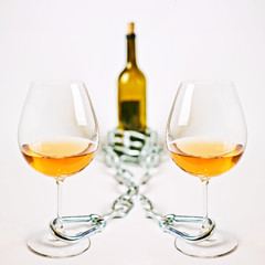 Glasses of light wine  chain and  bottle