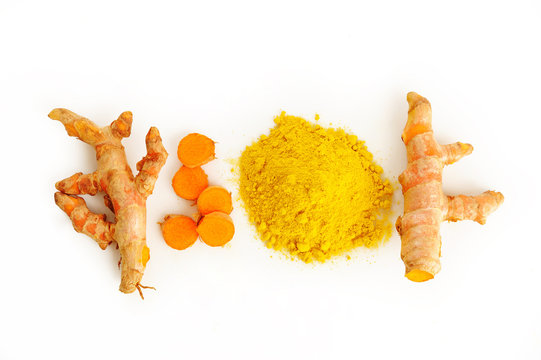 Turmeric root and powder on white