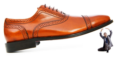 Woman domination concept with shoes and man