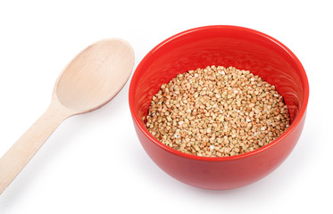 Raw buckwheat in plate isolated on white