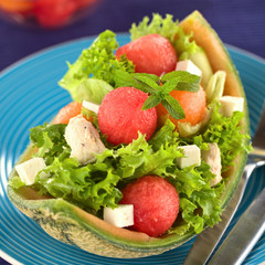 Salad made of melon, chicken, cucumber, cheese, lettuce