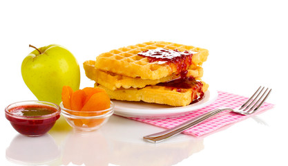 Tasty waffles with jam on plate isolated on white