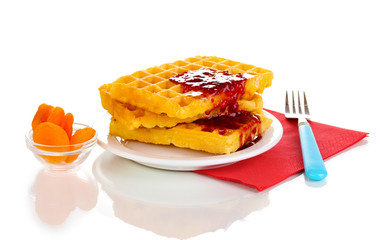 Tasty waffles with jam on plate isolated on white