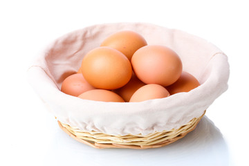 brown eggs in basket isolated on white