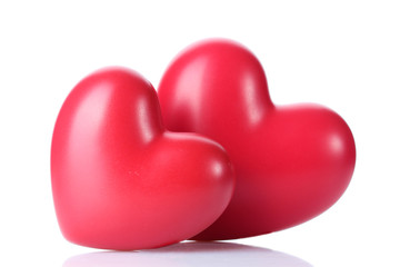 two decorative red hearts isolated on white.