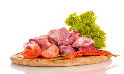 Pieces of raw meat and vegetables