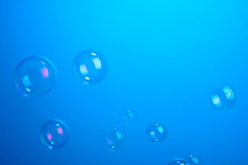 Soap bubbles on blue background