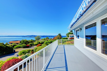 Front door porch with water view and grey house exterior.