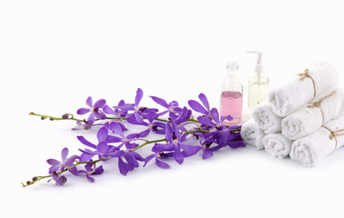 roller towel with branch pink orchids and massage oil