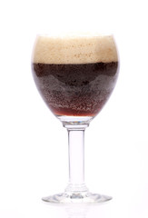 glass of a dark beer on a white background