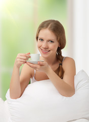 beautiful girl drinking coffee in bed