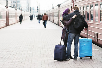 Happy young couple on railway station platform