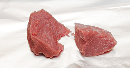 Piece of crude meat in a foil it is ready to preparation