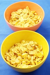 yellow and orange bowls with corn flakes