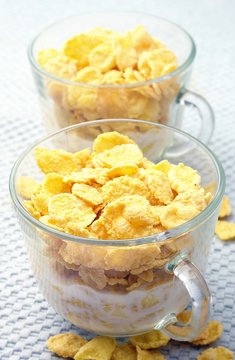 two glass bowls of cereal and milk