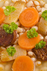 bean soup with carrots and meat garnish