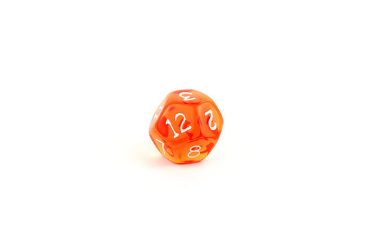 Photo of a translucent orange twelve-sided die on white