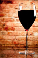 glass of wine on the background of a brick wall