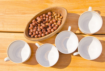 hazelnuts pack in wooden dish cups placed on table