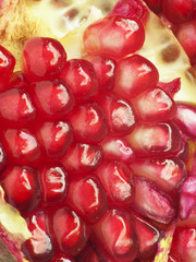 Extreme close up background of a red juicy ripe pomegranate frui