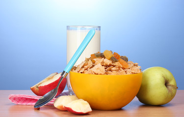 tasty cornflakes in yellow bowl, apples and glass of milk