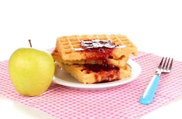 Tasty waffles with jam on plate isolated on white