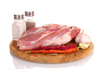 Raw meat and vegetables on a wooden board isolated on whitе